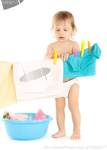 Image of baby doing laundry