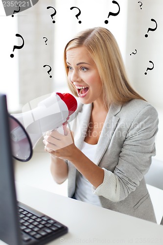 Image of crazy businesswoman shouting in megaphone