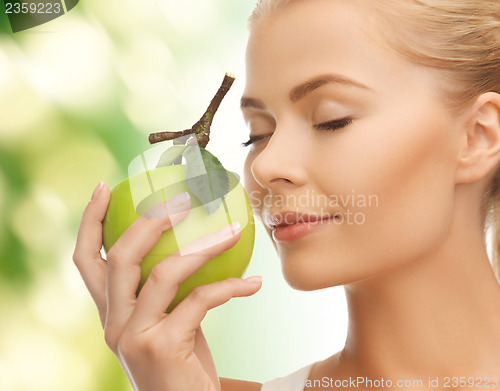 Image of woman smelling apple