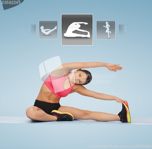 Image of woman stretching on the floor