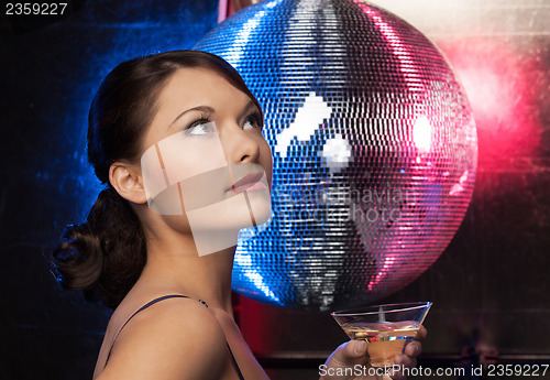 Image of woman with cocktail and disco ball