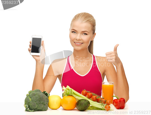 Image of woman with fruits, vegetables and smartphone