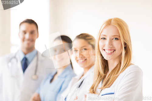 Image of female doctor in front of medical group