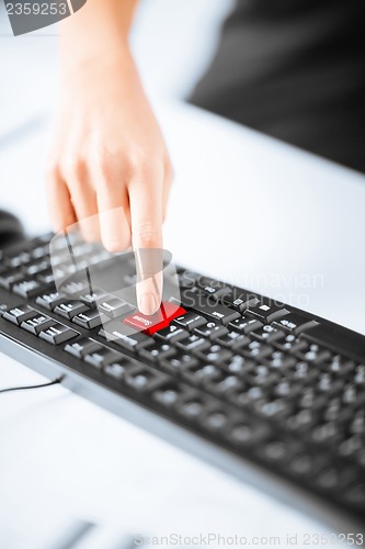 Image of hand pressing success button on keyboard