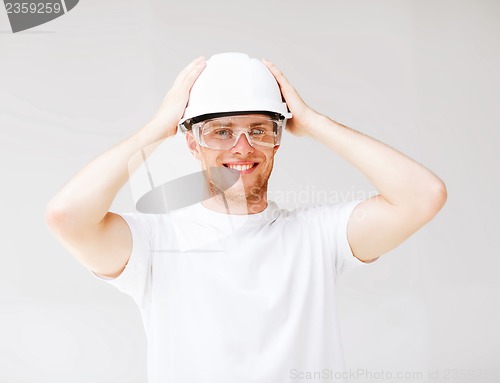 Image of male architect in helmet with safety glasses