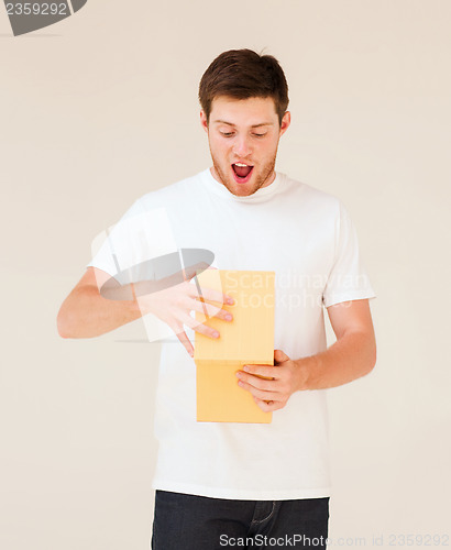 Image of man in white t-shirt with gift box
