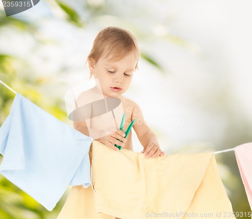 Image of baby doing laundry