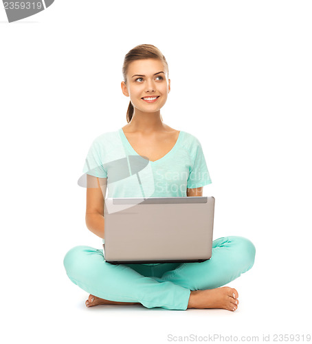 Image of young girl sitting on the floor with laptop