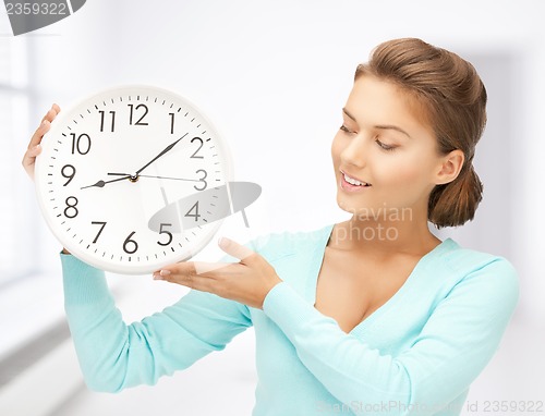 Image of woman with wall clock