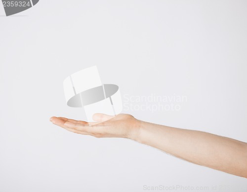 Image of mans hand showing something