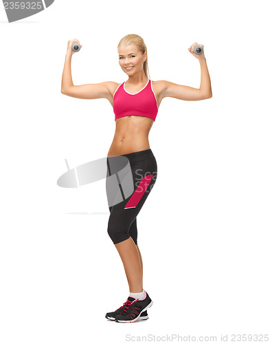 Image of young sporty woman with light dumbbells