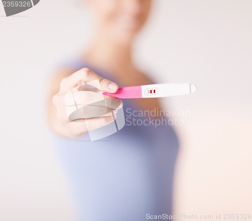 Image of woman with pregnancy test