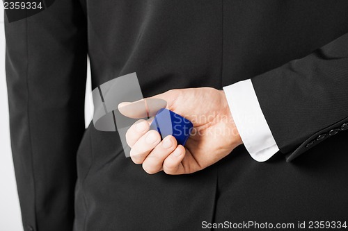 Image of man with gift box in suit