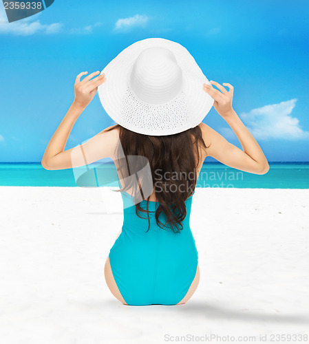 Image of model posing in swimsuit with hat