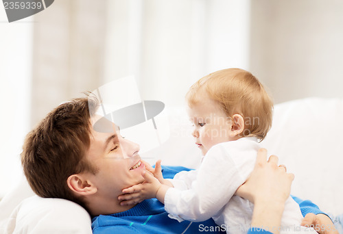 Image of happy father with adorable baby