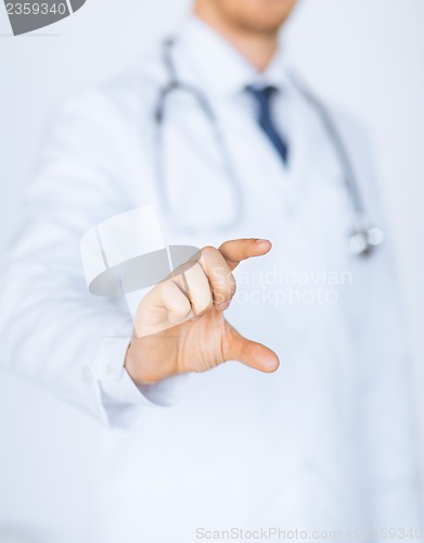 Image of male doctor holding something in his hand