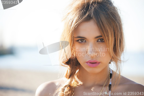 Image of fashion model posing on the beach