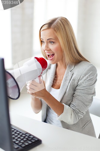 Image of crazy businesswoman shouting in megaphone