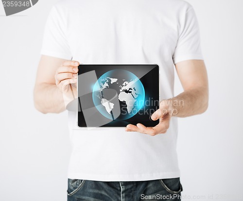 Image of man hands holding tablet pc with sign of globe