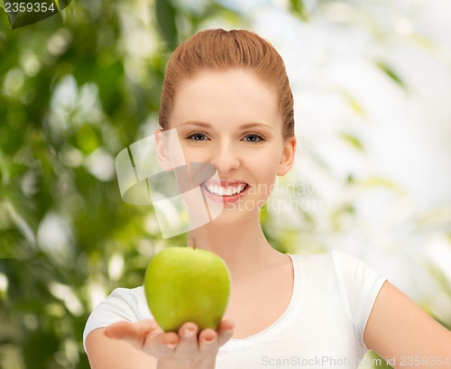 Image of young beautiful woman with green apple