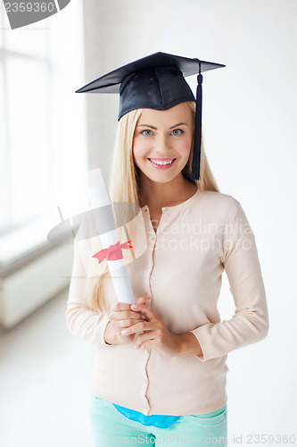 Image of student in graduation cap with certificate