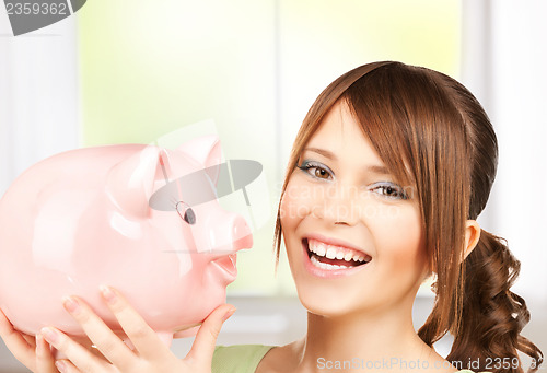 Image of lovely girl with big piggy bank