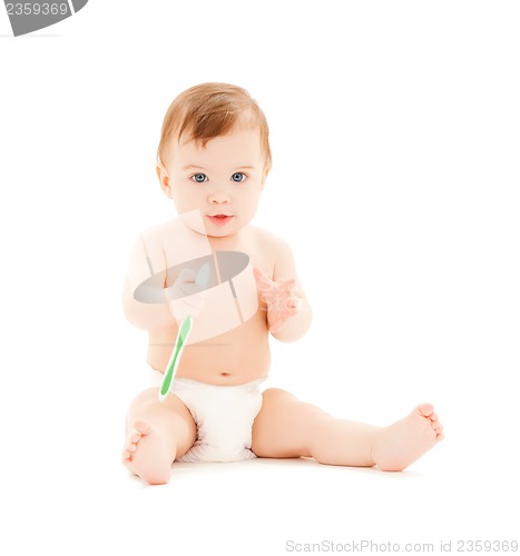 Image of curious baby brushing teeth