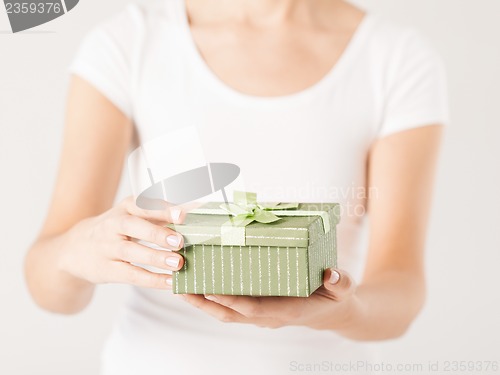 Image of woman hands with gift box