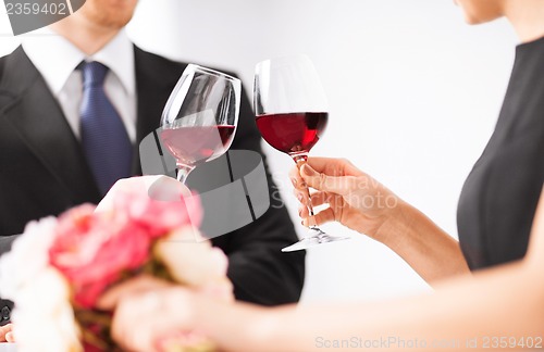 Image of engaged couple with wine glasses