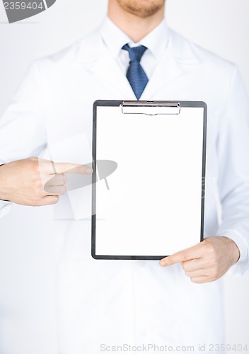 Image of doctor pointing at blank white paper