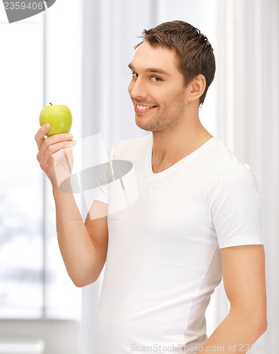 Image of man in white shirt with green apple