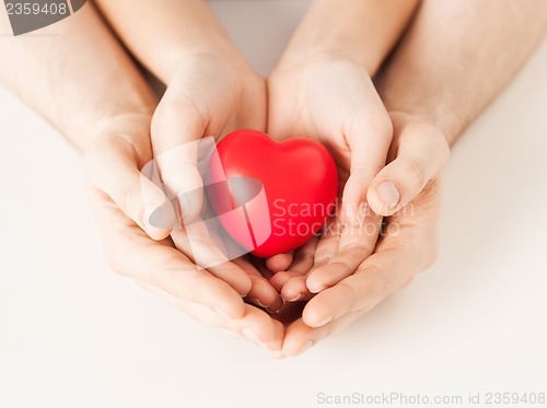 Image of woman and man hands with heart
