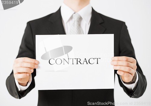 Image of man hands holding contract paper