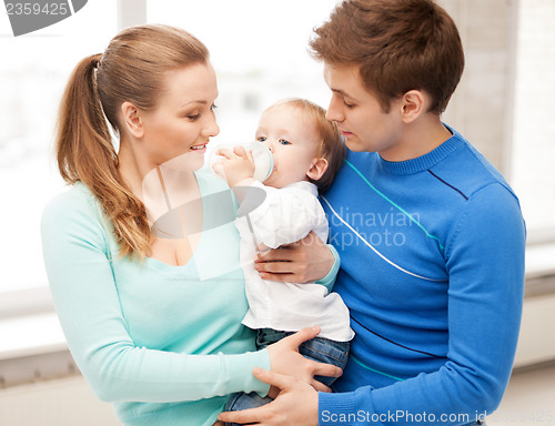 Image of family and adorable baby with feeding-bottle