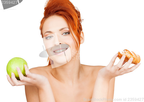 Image of pretty woman with apple and cake