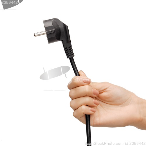 Image of hand holding black electrical plug with wire