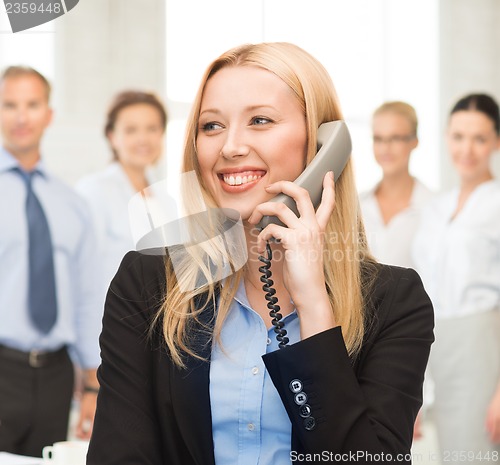 Image of woman with phone in office