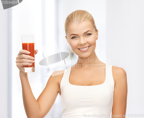 Image of woman holding glass of tomato juice