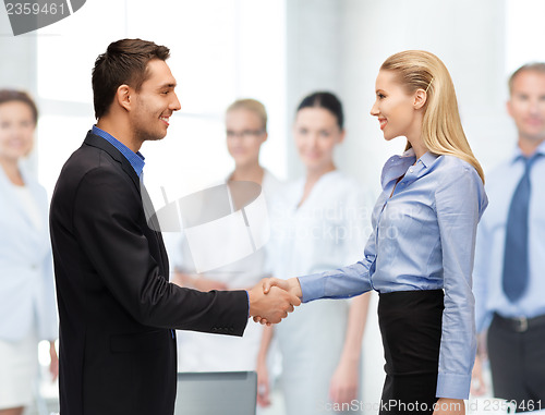 Image of man and woman shaking their hands