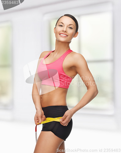 Image of sporty woman with measuring tape