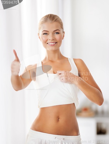 Image of sporty woman showing thumbs up