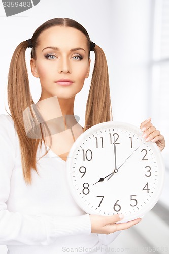 Image of woman holding big clock