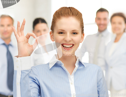 Image of young woman showing ok sign