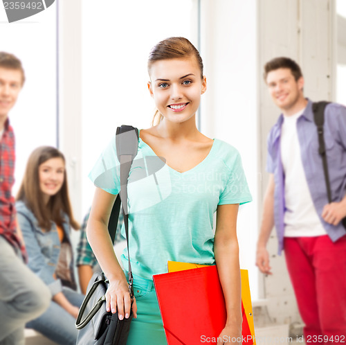 Image of student girl with school bag and color folders