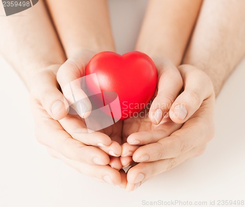 Image of woman and man hands with heart