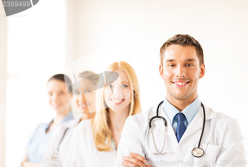 Image of male doctor in front of medical group