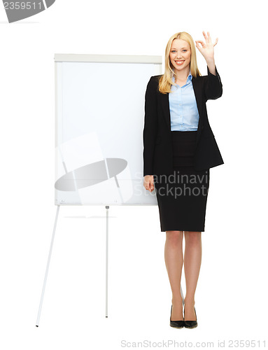 Image of businesswoman with flipchart in office