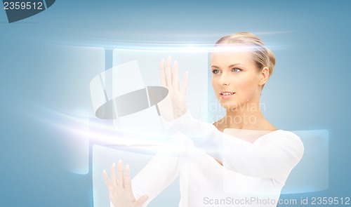 Image of businesswoman touching virtual screen