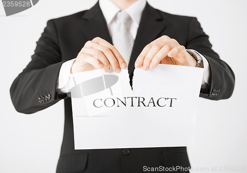 Image of man hands tearing contract paper