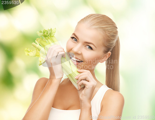 Image of woman biting piece of celery or green salad